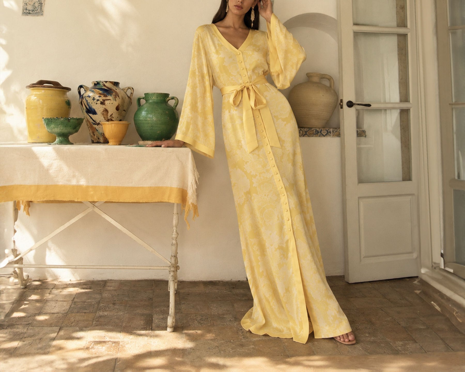 The Sol Return kaftan at home, sash tied at the waist
