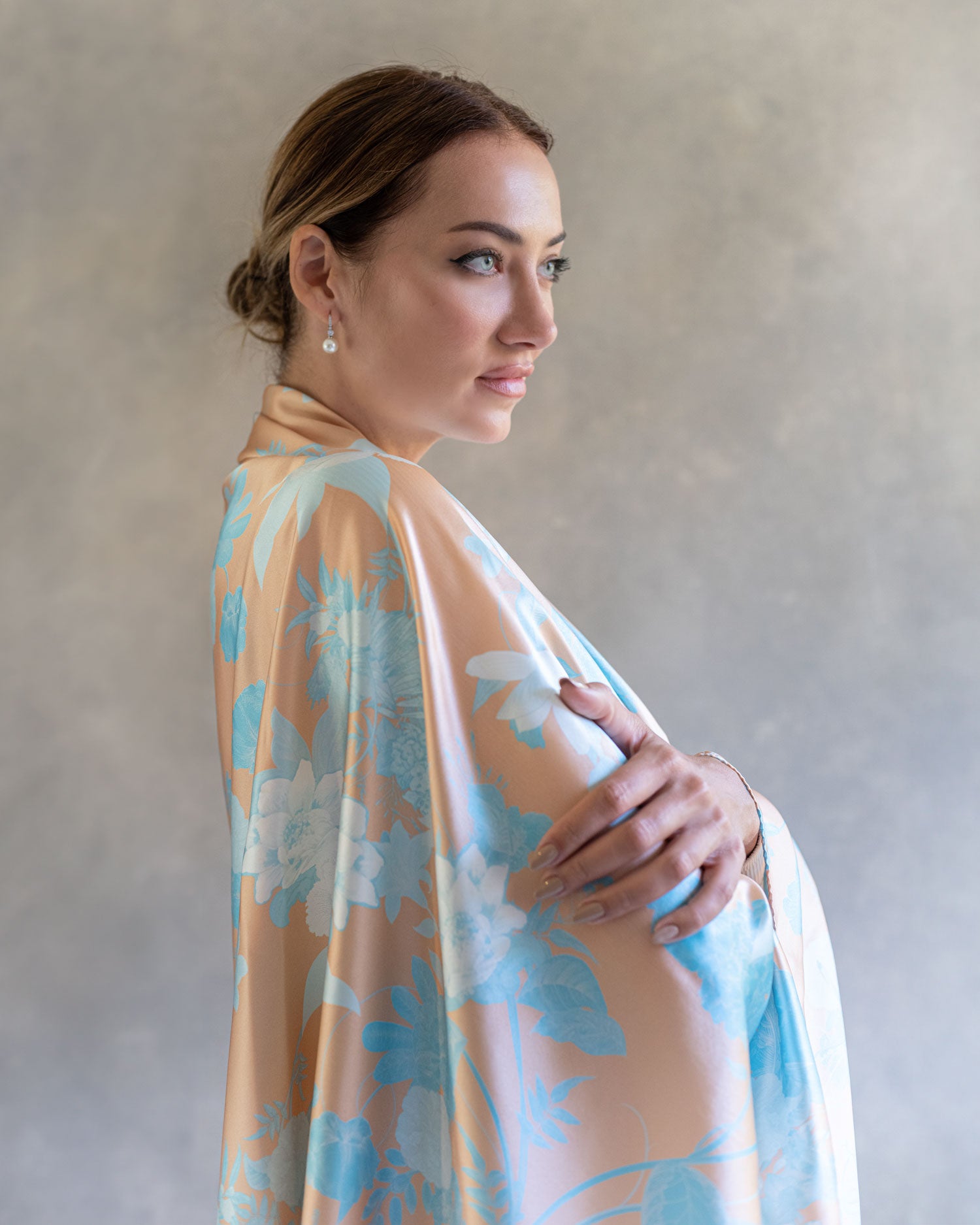 Close up of woman wearing orange and blue sarong pareo elegantly draped as a shawl