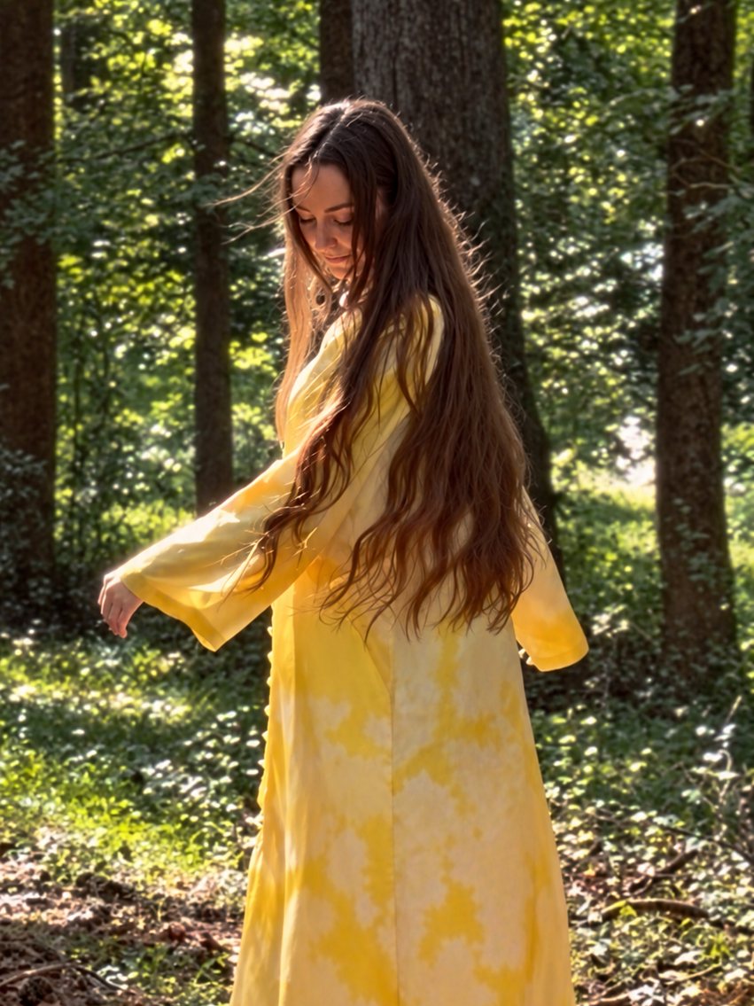 Yellow damask kaftan worn in a sunlit forest